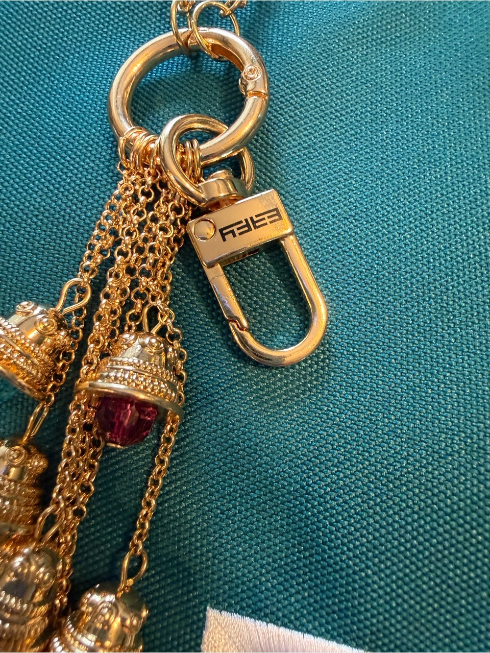 Effy Teal Canvas Logo Tote with Gold color bag charm with 8 Effy bell charms. - Picture 3 of 6